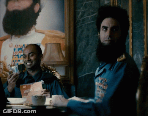 Bearded Man Sitting At Coffee Table GIF