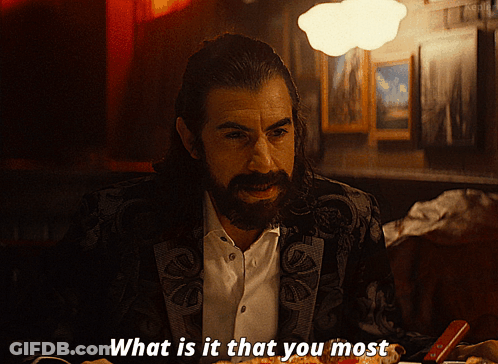 A Man With A Beard Is Sitting At A Table With A Plate Of Food And Says What Is It That You Most GIF