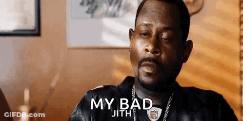 A Man With A Beard Is Sitting At A Table With His Eyes Closed And A Nfl Jersey On . GIF