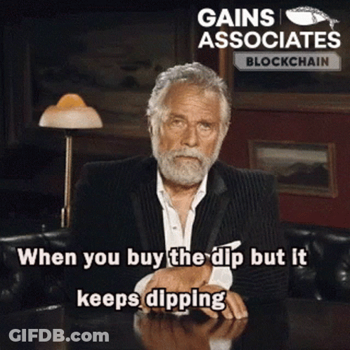 A Man With A Beard Is Sitting At A Table With The Words Gains Associates Blockchain Written On The Bottom GIF