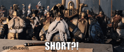 A Man With A Beard Is Sitting At A Table With The Words Short Written On The Table GIF