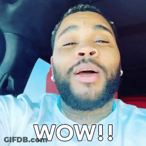 A Man With A Beard Is Sitting In A Car And Making A Funny Face . GIF