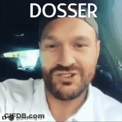 A Man With A Beard Is Sitting In A Car With The Word Dossier Written Above Him . GIF