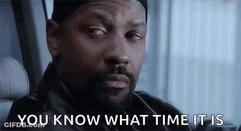 A Man With A Beard Is Sitting In A Car With The Words `` You Know What Time It Is '' Written On His Face . GIF