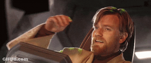 A Man With A Beard Is Sitting In A Chair Holding Something GIF