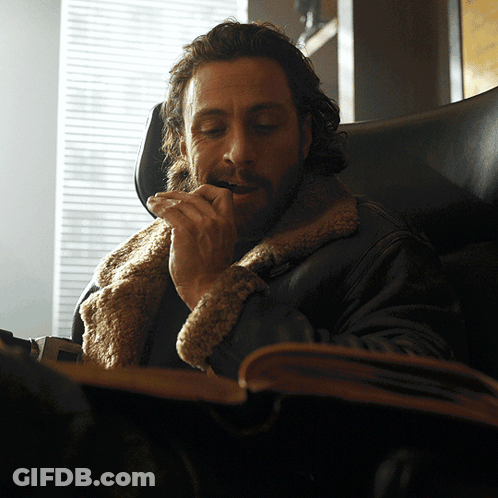 Bearded Man Sitting And Smoking Cigarette GIF