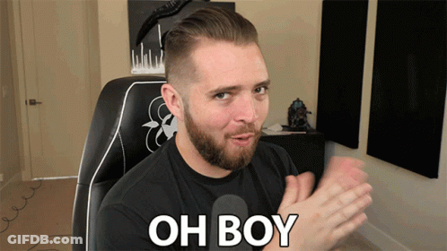 A Man With A Beard Is Sitting In A Chair With The Words Oh Boy Written On His Chest GIF