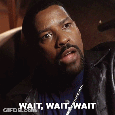 A Man With A Beard Is Sitting In A Chair With The Words Wait Wait Wait Written On The Bottom GIF