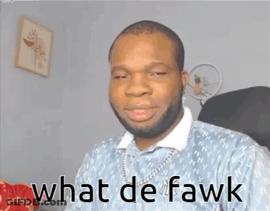 A Man With A Beard Is Sitting In A Chair With The Words What De Fawk Written On His Face GIF