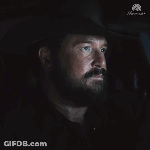 A Man With A Beard Is Sitting In A Dark Room With The Word Nope On The Bottom GIF