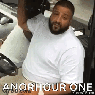 A Man With A Beard Is Sitting In A Golf Cart With The Words `` An Hour One '' Written On It . GIF