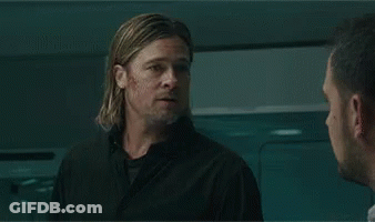A Man With A Beard Is Sitting In A Laboratory Looking At Something . GIF