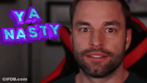 A Man With A Beard Is Sitting In A Red Chair With The Words Ya Nasty Above His Head GIF