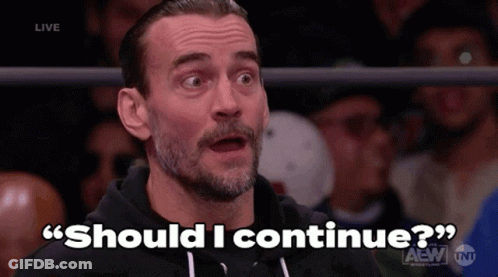 A Man With A Beard Is Sitting In Front Of A Crowd And Says Should I Continue ? GIF