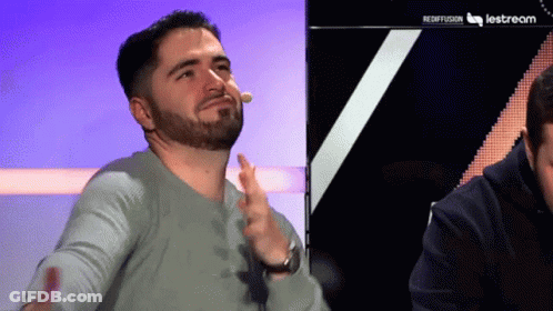 A Man With A Beard Is Sitting In Front Of A Lestream Logo GIF