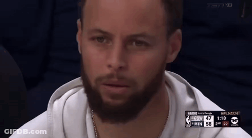 A Man With A Beard Is Sitting In Front Of A Screen That Says Tnt On It GIF