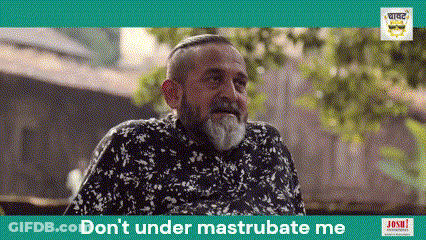 A Man With A Beard Is Sitting In Front Of A Sign That Says Don 'T Under Mastrubate Me GIF