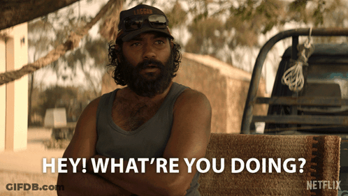 A Man With A Beard Is Sitting In Front Of A Truck And Says " Hey What 'Re You Doing " GIF