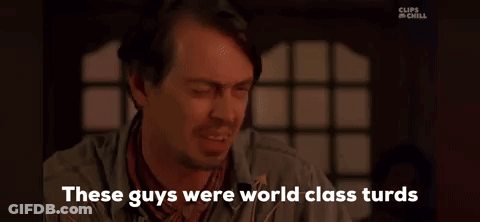 A Man With A Beard Is Sitting In Front Of A Window And Talking To Someone . GIF