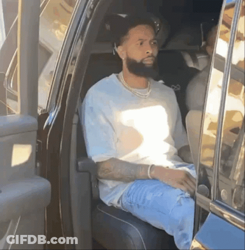 A Man With A Beard Is Sitting In The Back Of A Car GIF
