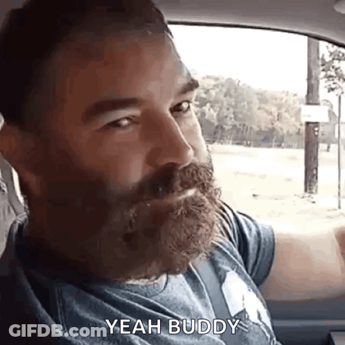 A Man With A Beard Is Sitting In The Back Seat Of A Car And Saying Yeah Buddy . GIF
