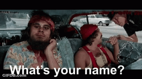 A Man With A Beard Is Sitting In The Back Seat Of A Car While A Police Officer Talks To Him . GIF