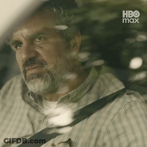 A Man With A Beard Is Sitting In The Back Seat Of A Car With A Hbo Max Logo Behind Him GIF