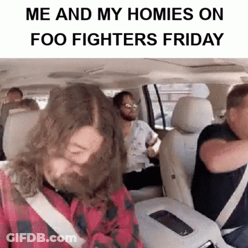 A Man With A Beard Is Sitting In The Back Seat Of A Car With Other People .. GIF