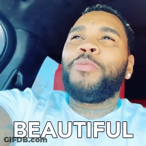 A Man With A Beard Is Sitting In The Driver 'S Seat Of A Car And The Word Beautiful Is On The Screen . GIF