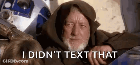 A Man With A Beard Is Sitting Next To A R2d2 Robot . GIF