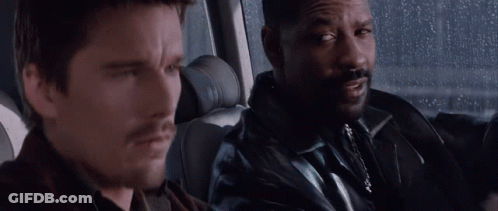 A Man With A Beard Is Sitting Next To Another Man In A Car . GIF