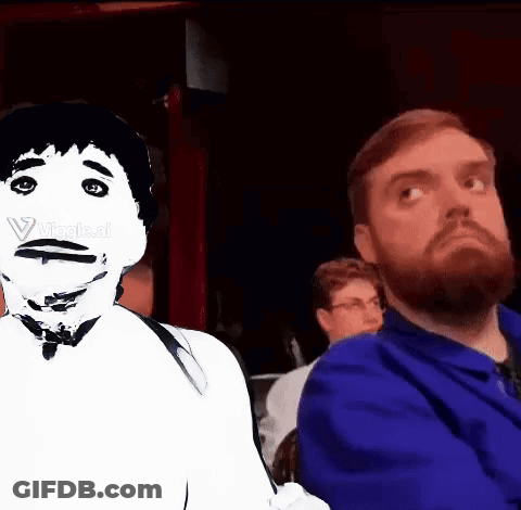 A Man With A Beard Is Sitting Next To Another Man With A White Face GIF