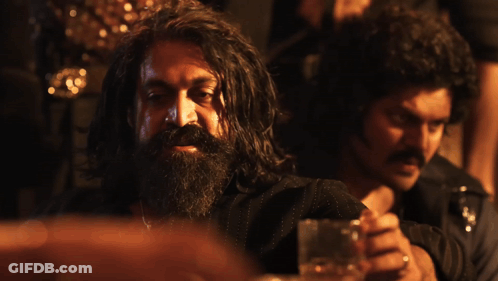 A Man With A Beard Is Sitting Next To Another Man With The Words Absolute Cinema Below Him GIF