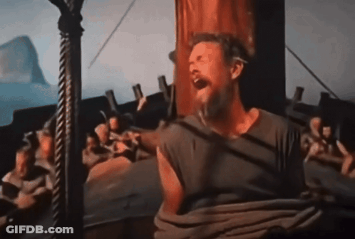 A Man With A Beard Is Sitting On A Boat And Screaming GIF