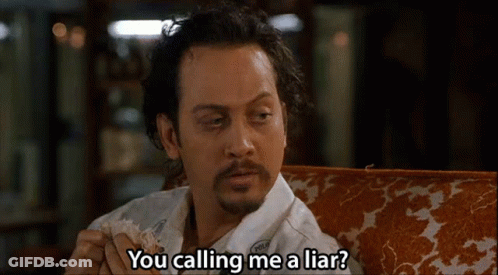 A Man With A Beard Is Sitting On A Couch And Saying You Calling Me A Liar . GIF