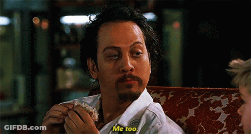 A Man With A Beard Is Sitting On A Couch Eating A Sandwich And Saying Me Too GIF