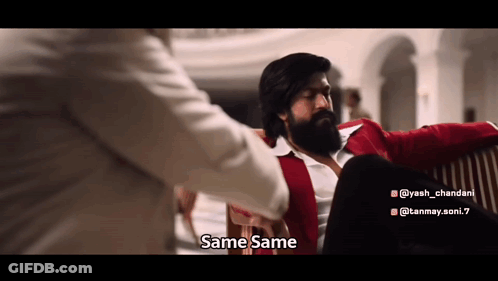 A Man With A Beard Is Sitting On A Couch With Another Man And Talking To Him . GIF