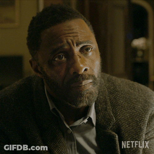 A Man With A Beard Is Sitting With His Hands Folded In Front Of A Netflix Sign GIF