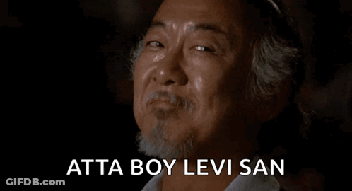 A Man With A Beard Is Smiling And Crying With The Words Atta Boy Levi San Written Below Him . GIF