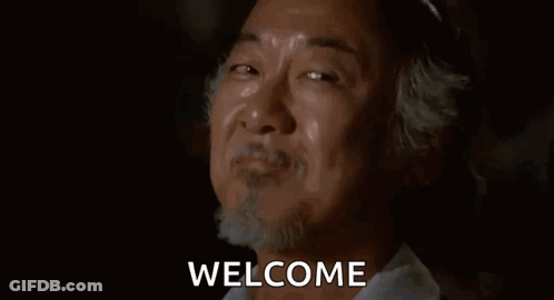 A Man With A Beard Is Smiling And Crying With The Words Welcome Behind Him . GIF