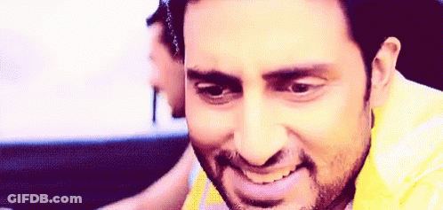 A Man With A Beard Is Smiling And Looking At The Camera . GIF