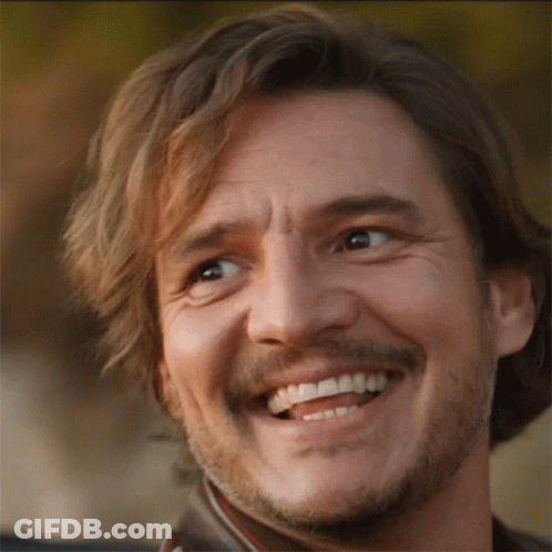 A Man With A Beard Is Smiling And Looking Up GIF