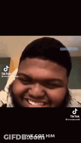 A Man With A Beard Is Smiling And Making A Funny Face On A Tik Tok Video . GIF