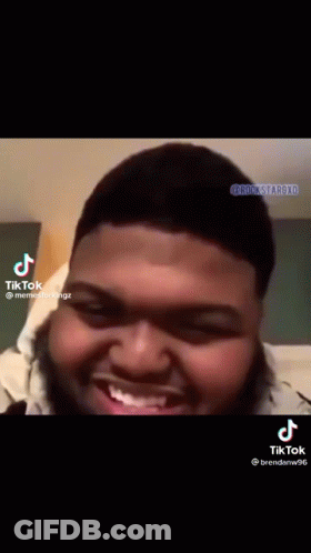 A Man With A Beard Is Smiling And Making A Funny Face On A Tiktok Video . GIF