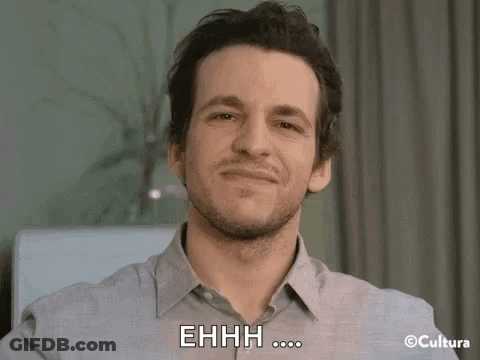 A Man With A Beard Is Smiling And Making A Funny Face While Saying Ehhh . GIF