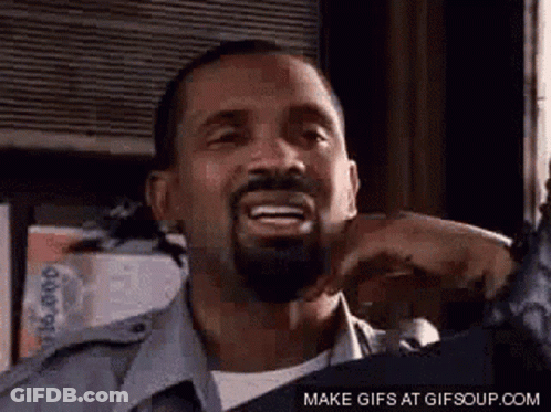 A Man With A Beard Is Smiling And Making A Funny Face With His Mouth Open . GIF