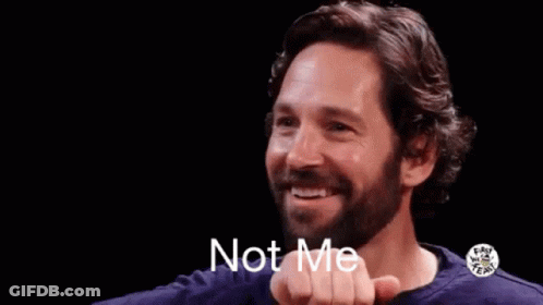 A Man With A Beard Is Smiling And Making A Gesture With His Hand That Says `` Not Me '' . GIF