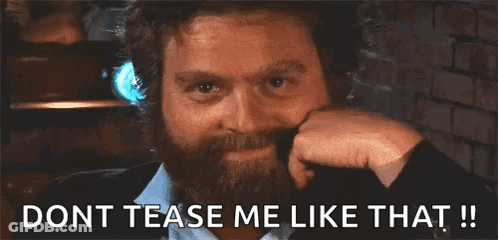 A Man With A Beard Is Smiling And Says " Dont Tease Me Like That !! " GIF