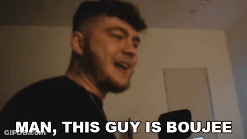 A Man With A Beard Is Smiling And Says Man , This Guy Is Boujee . GIF