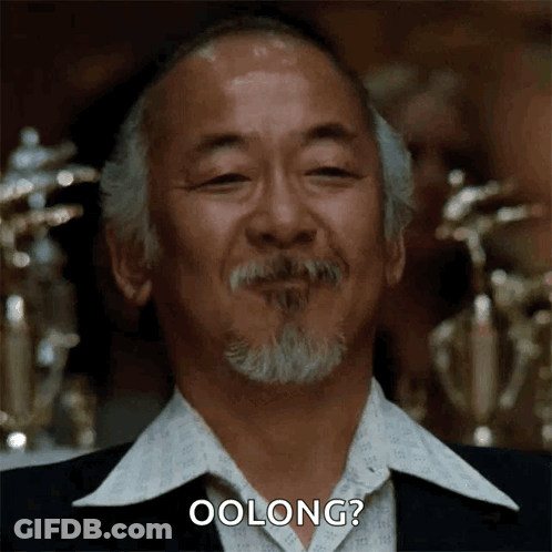 A Man With A Beard Is Smiling And Says Oolong ? GIF